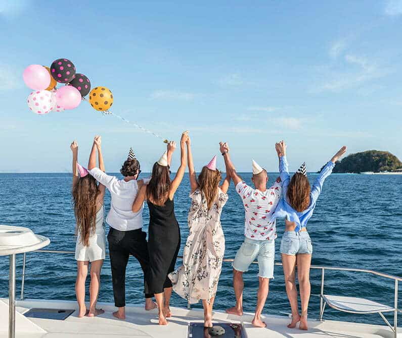 10-reasons-to-host-your-next-class-reunion-on-a-boat a group of people on a beach