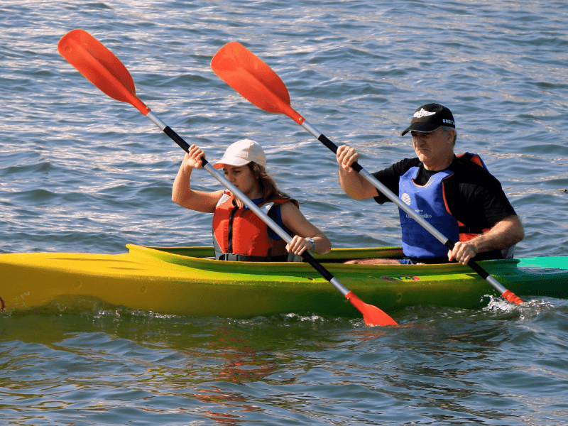 a man riding on the back of a boat in the water
