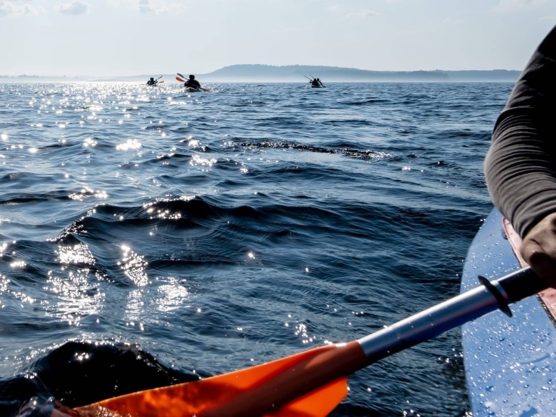 a person standing next to a body of water