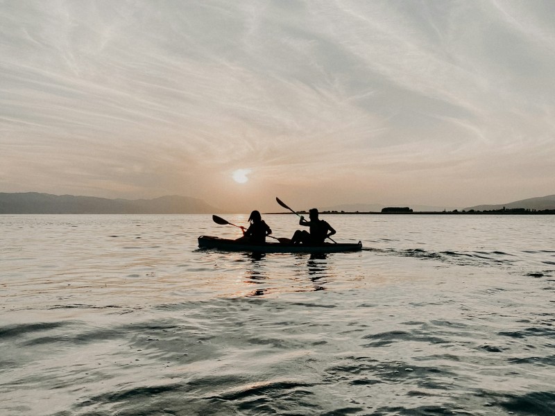 a person standing next to a body of water
