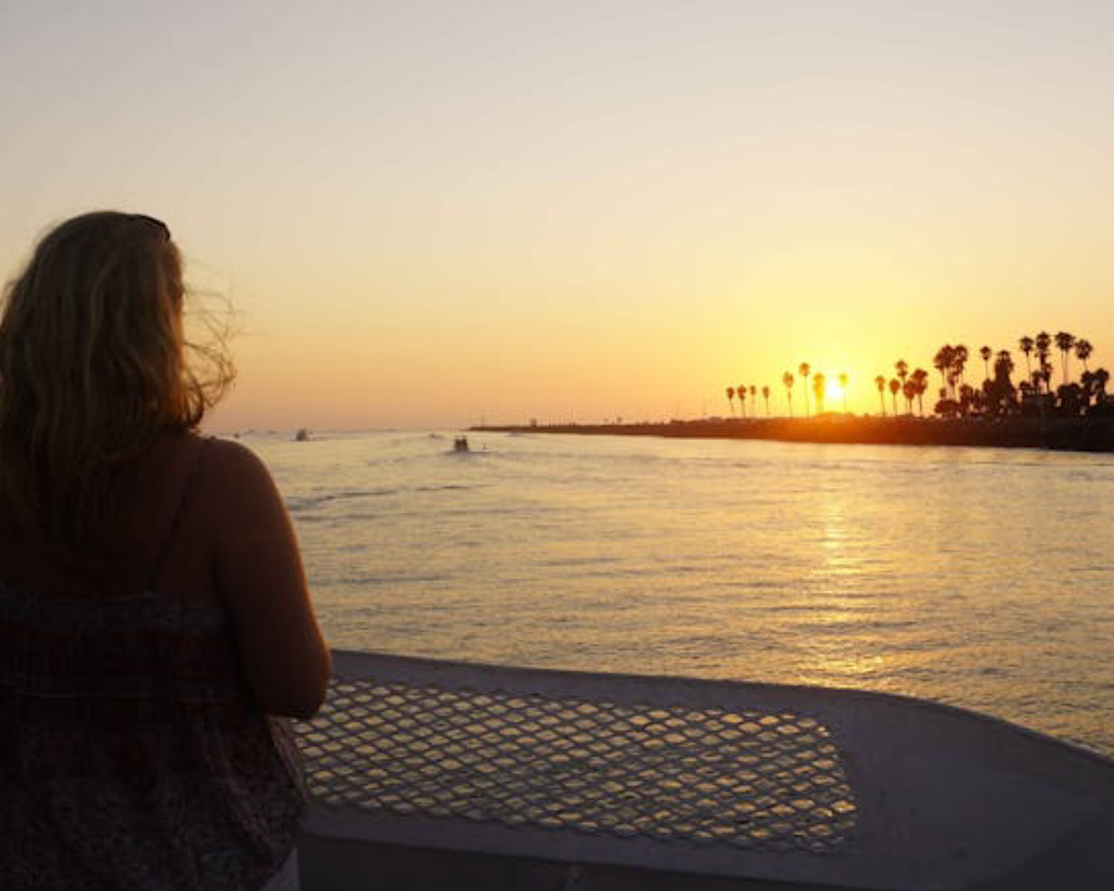 a person standing in front of a body of water