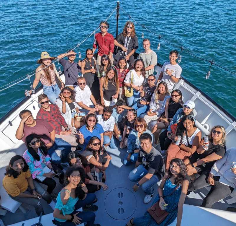 a group of people swimming in a body of water posing for the camera