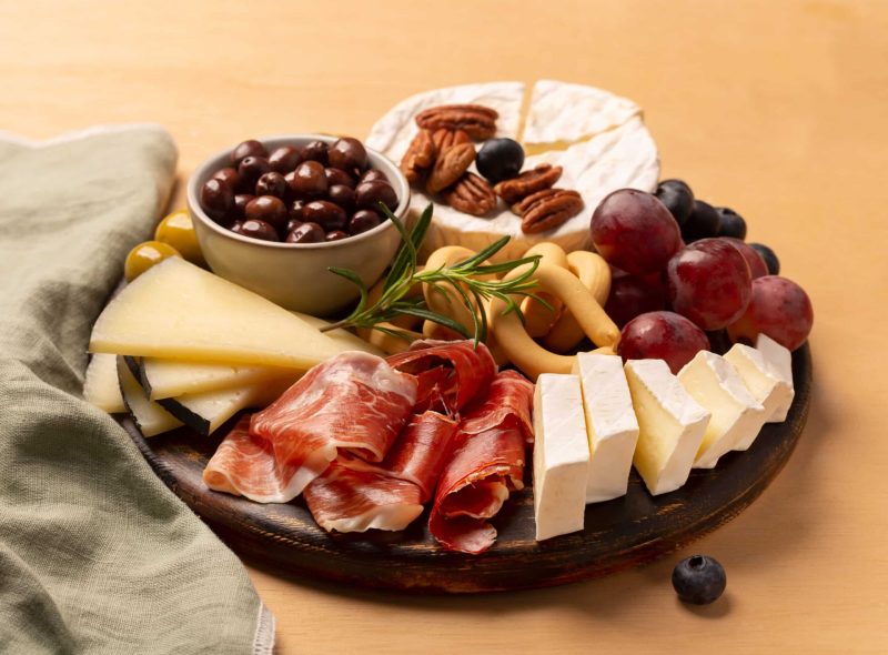 charcuterie-board-with-jamon-pork-sausage-with-pe-2021-08-31-22-17-31-utc-scaled a bowl of fruit on a plate