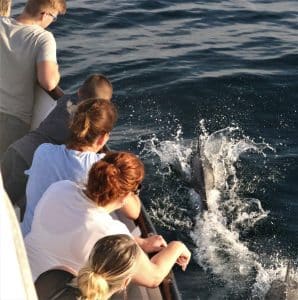 a young girl riding a wave on a surfboard in the water
