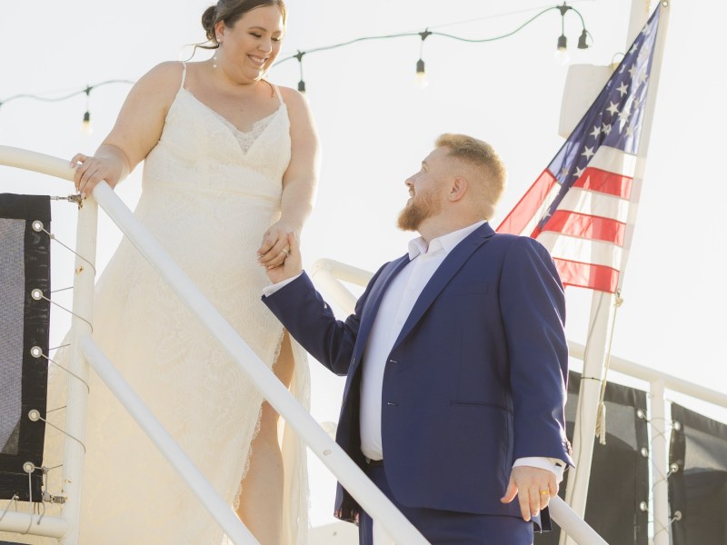 a man and a woman standing on a bridge