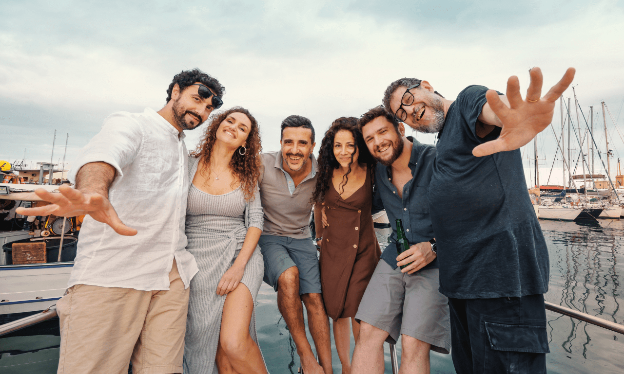 Celebrate Fall in San Diego Group of six people smiling on a dock with boats in the background.
