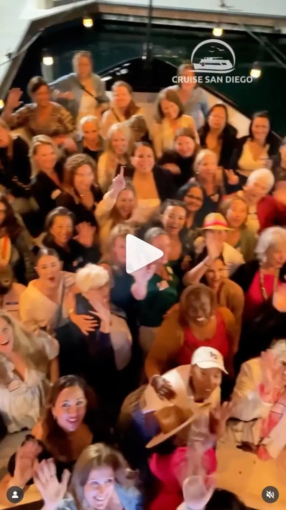 Group of people smiling and waving on a boat with 'Cruise San Diego' text overlay.